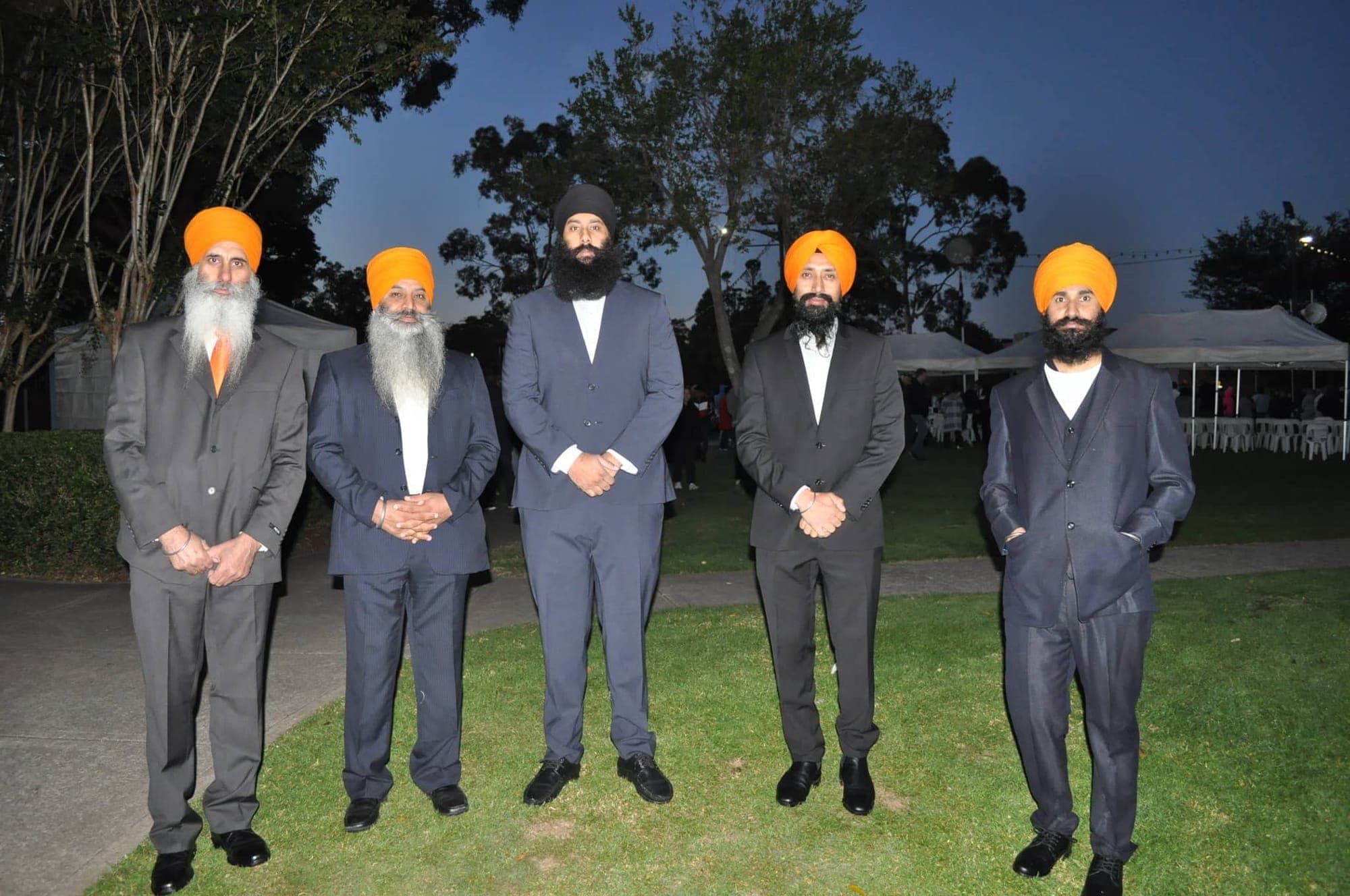 AKA members standing together at an evening community gathering in a park