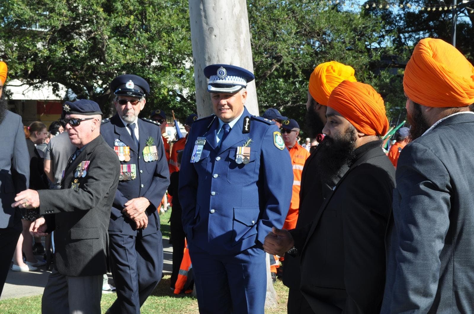 AKA members alongside police and emergency service personnel at a commemoration