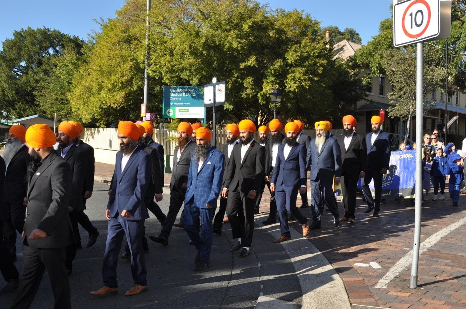 AKA members walking through a town centre in the ANZAC Day march